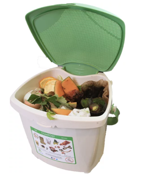 Image of a green and gray compost pail filled with produce scraps and coffee grounds